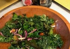 A wooden bowl of salad on top of a table.