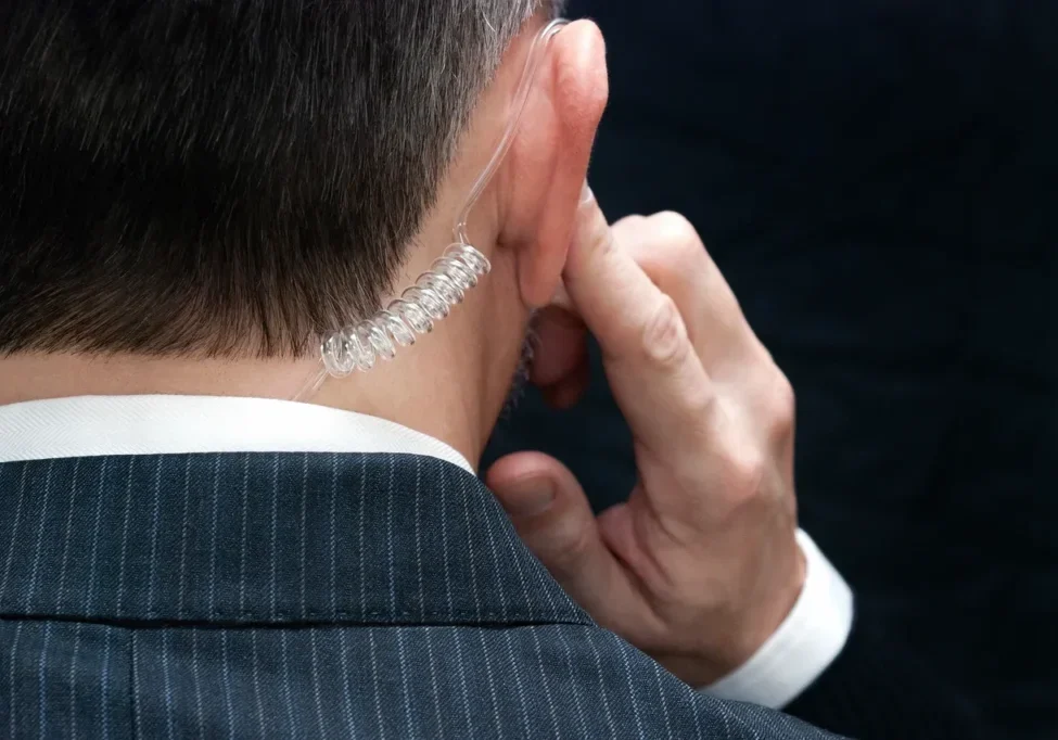 A man in a suit is talking on his phone.